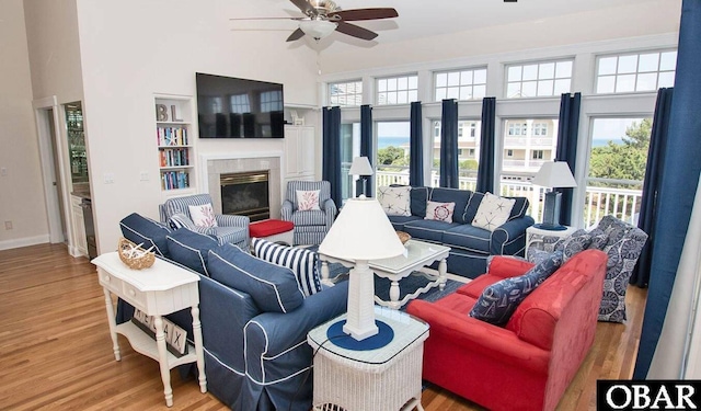 273 Whites Pt Lot 183, Corolla, NC 27927 - living area with a ceiling fan, wood finished floors, a fireplace, and a towering ceiling