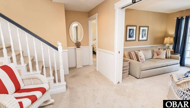 273 Whites Pt Lot 183, Corolla, NC 27927 - living area featuring carpet, a wainscoted wall, and stairway