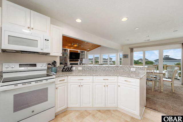 1045 Whalehead Dr Lot 27, Corolla, NC 27927 - kitchen featuring white appliances, white cabinetry, a peninsula, light stone counters, and recessed lighting