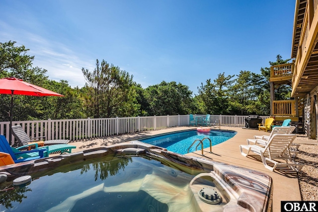 1045 Whalehead Dr Lot 27, Corolla, NC 27927 - view of swimming pool with an outdoor hot tub, a wooden deck, and view of wooded area