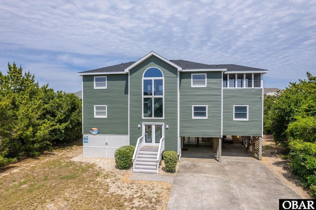 1045 Whalehead Dr Lot 27, Corolla, NC 27927 - rear view of house with a carport, driveway, and a shingled roof