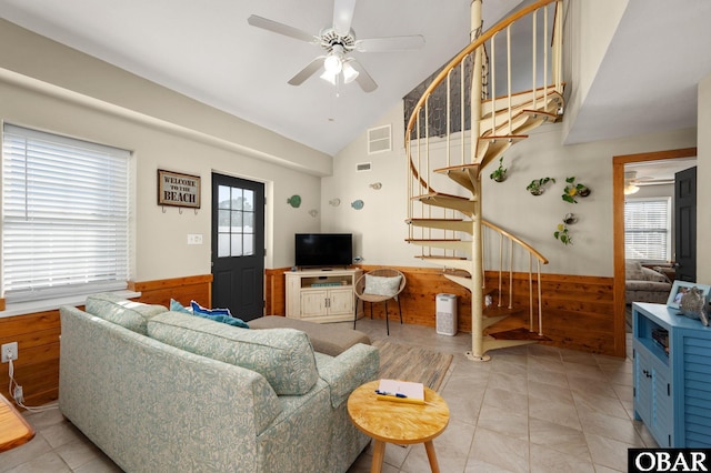 300 S Virginia Dare Trl Lot 1, Kill Devil Hills, NC 27948 - living area with stairway, wainscoting, ceiling fan, plenty of natural light, and wooden walls