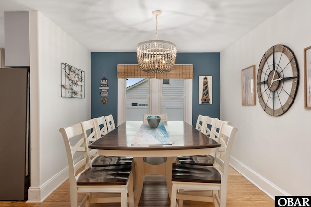 300 S Virginia Dare Trl Lot 1, Kill Devil Hills, NC 27948 - dining area with a chandelier and light wood-type flooring