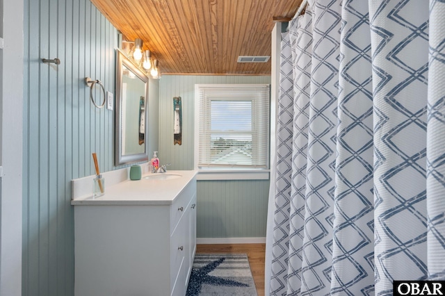 300 S Virginia Dare Trl Lot 1, Kill Devil Hills, NC 27948 - bathroom with wood ceiling, vanity, wood finished floors, wood walls, and a shower with shower curtain