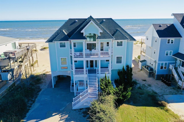 bird's eye view with a water view and a beach view