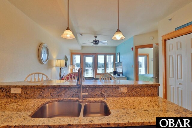 107 W Gray Eagle St Unit 112A, Nags Head, NC 27959 - kitchen featuring a sink, decorative light fixtures, light stone counters, and a ceiling fan