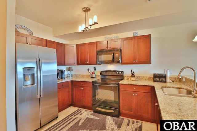 107 W Gray Eagle St Unit 112A, Nags Head, NC 27959 - kitchen featuring black appliances, a sink, a chandelier, light stone countertops, and hanging light fixtures