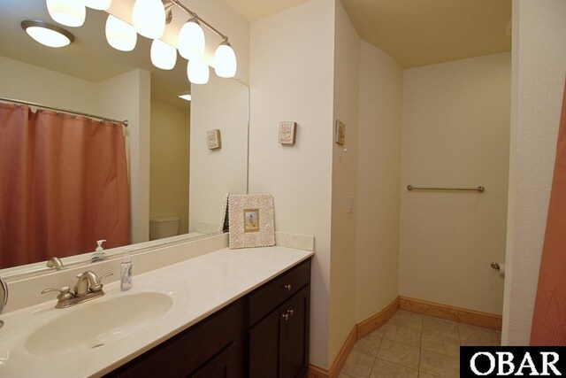 107 W Gray Eagle St Unit 112A, Nags Head, NC 27959 - full bathroom featuring toilet, vanity, tile patterned flooring, and baseboards