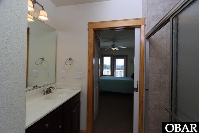 107 W Gray Eagle St Unit 112A, Nags Head, NC 27959 - full bathroom featuring ensuite bath, vanity, a ceiling fan, and a tile shower