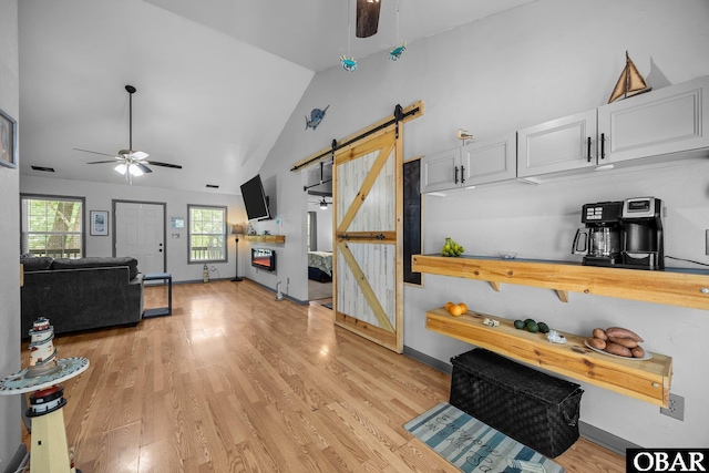 103 Nathan Dr Lot # 2, Grandy, NC 27939 - living area with ceiling fan, a barn door, light wood-style flooring, and high vaulted ceiling