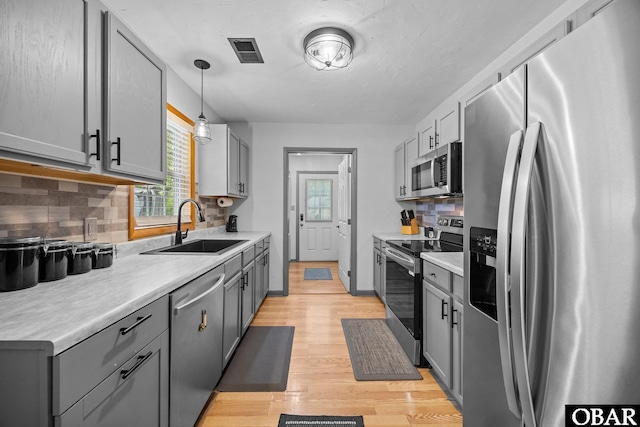 103 Nathan Dr Lot # 2, Grandy, NC 27939 - kitchen featuring appliances with stainless steel finishes, healthy amount of natural light, light wood finished floors, and gray cabinets