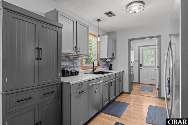 103 Nathan Dr Lot # 2, Grandy, NC 27939 - kitchen featuring stainless steel appliances, gray cabinetry, light wood-type flooring, light countertops, and tasteful backsplash