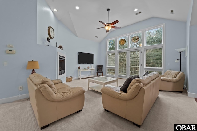 living room featuring visible vents, light carpet, high vaulted ceiling, and a ceiling fan