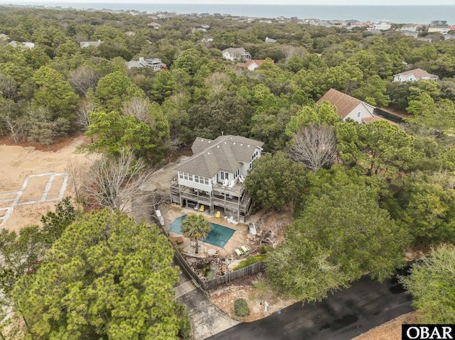 aerial view featuring a wooded view