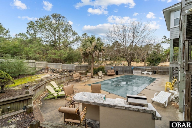 view of swimming pool featuring a patio area, a fenced in pool, and a fenced backyard