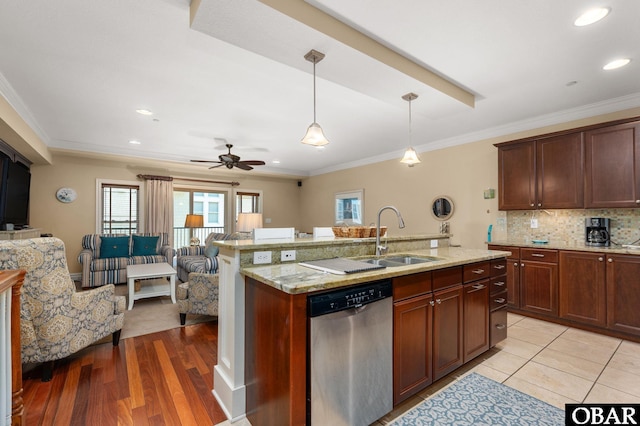 kitchen with stainless steel dishwasher, a sink, open floor plan, decorative backsplash, and crown molding