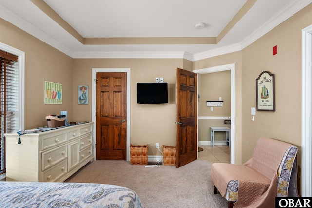 bedroom featuring a tray ceiling, light colored carpet, ornamental molding, and baseboards