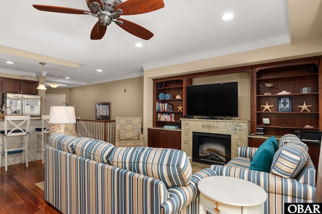 living room with recessed lighting, ornamental molding, a ceiling fan, a fireplace, and dark wood-style floors
