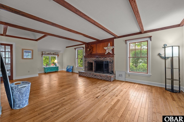 56 Ginguite Trl Lot 9, Southern Shores, NC 27949 - unfurnished living room with light wood-style flooring, baseboards, a fireplace, and healthy amount of natural light