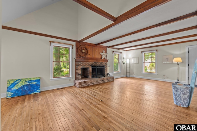 56 Ginguite Trl Lot 9, Southern Shores, NC 27949 - unfurnished living room with beam ceiling, baseboards, light wood-style flooring, and a fireplace