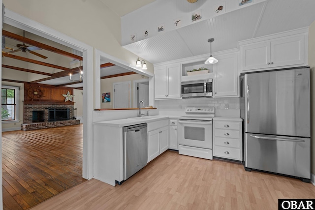 56 Ginguite Trl Lot 9, Southern Shores, NC 27949 - kitchen featuring stainless steel appliances, light wood-type flooring, light countertops, a sink, and beam ceiling