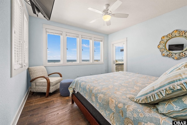 bedroom with dark wood-style flooring, ceiling fan, and baseboards