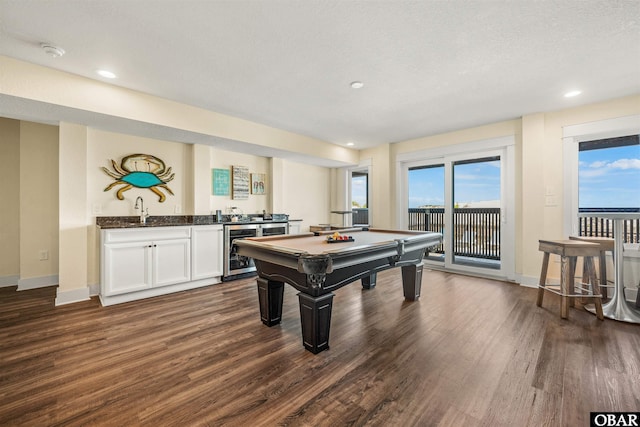 playroom with wine cooler, a sink, dark wood finished floors, and wet bar