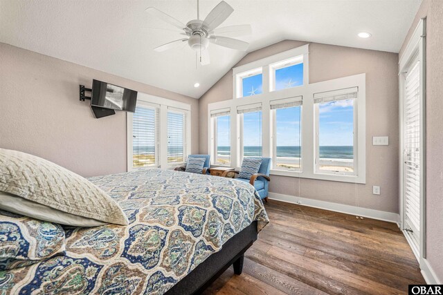 bedroom with dark wood-style floors, ceiling fan, vaulted ceiling, and baseboards