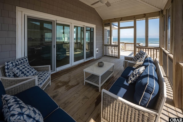 sunroom / solarium featuring wood ceiling, a water view, vaulted ceiling, and ceiling fan