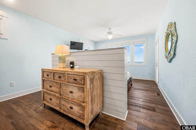 bedroom featuring ceiling fan, baseboards, visible vents, and dark wood finished floors