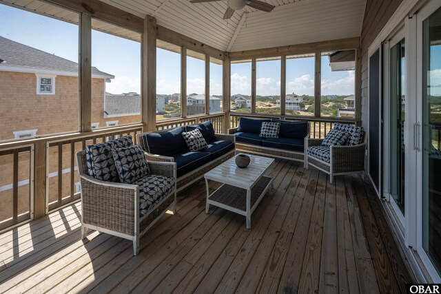 sunroom featuring vaulted ceiling and ceiling fan