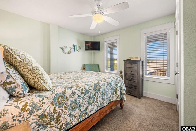 carpeted bedroom featuring ceiling fan and baseboards