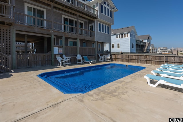 view of swimming pool with a patio area, fence, and a fenced in pool