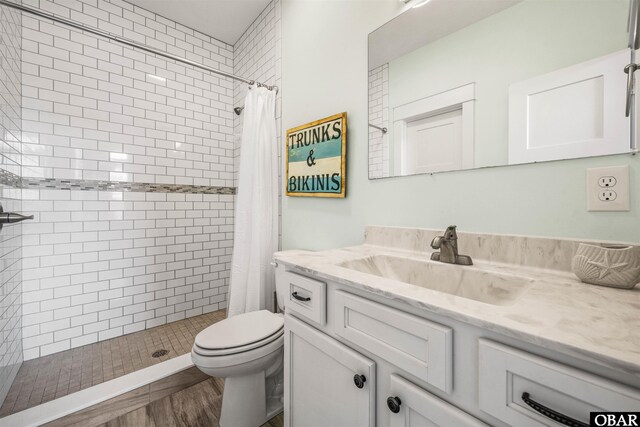 full bath with toilet, a shower stall, and vanity