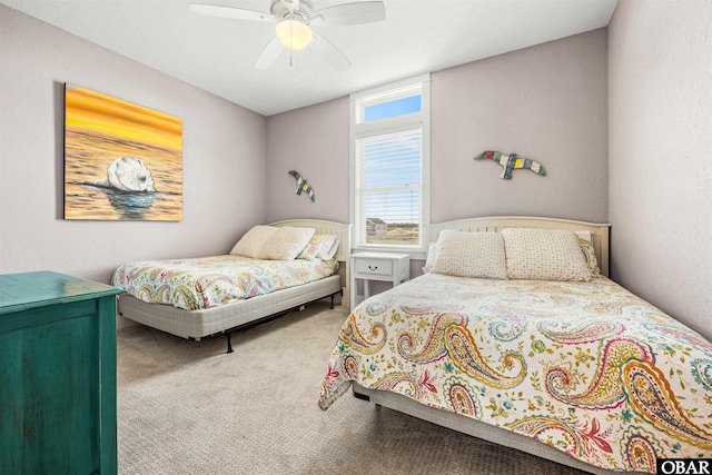 bedroom with ceiling fan, a textured wall, and carpet flooring