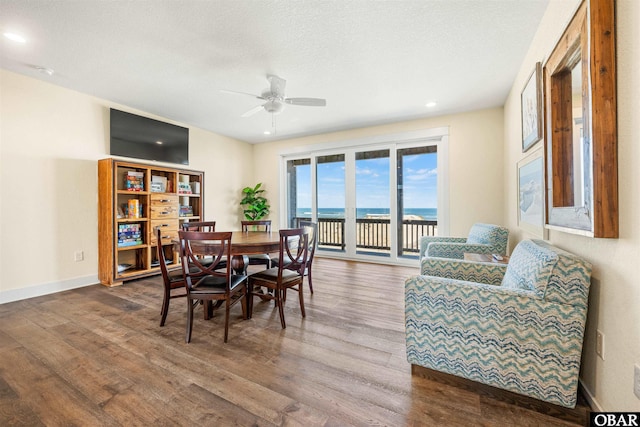 dining room featuring recessed lighting, ceiling fan, a textured ceiling, wood finished floors, and baseboards