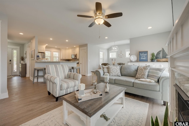 living room featuring recessed lighting, light wood finished floors, and ceiling fan