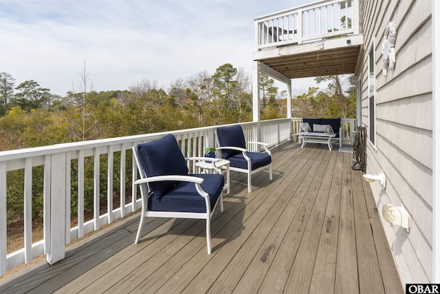 wooden terrace featuring outdoor lounge area