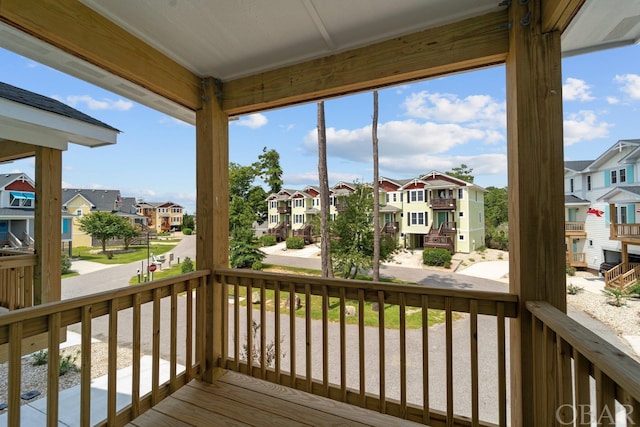 wooden terrace with a porch and a residential view