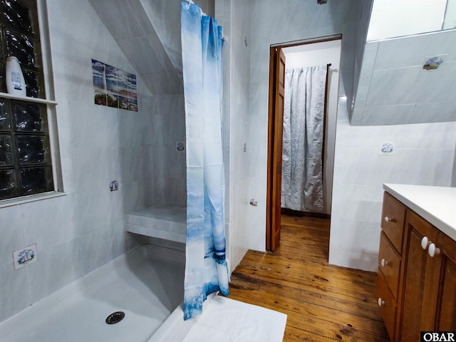 1218 Coral Ln Lot 4, Corolla, NC 27927 - full bathroom featuring hardwood / wood-style floors, a tile shower, vanity, and tile walls