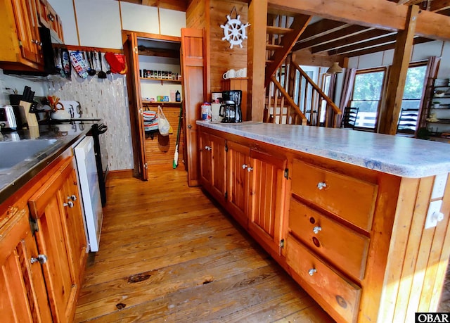 1218 Coral Ln Lot 4, Corolla, NC 27927 - kitchen with light wood-style flooring, a peninsula, white dishwasher, and brown cabinetry