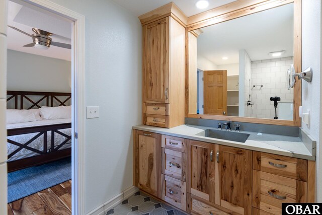 full bathroom featuring connected bathroom, vanity, baseboards, and ceiling fan