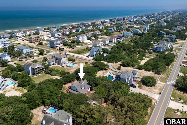 drone / aerial view with a water view and a residential view