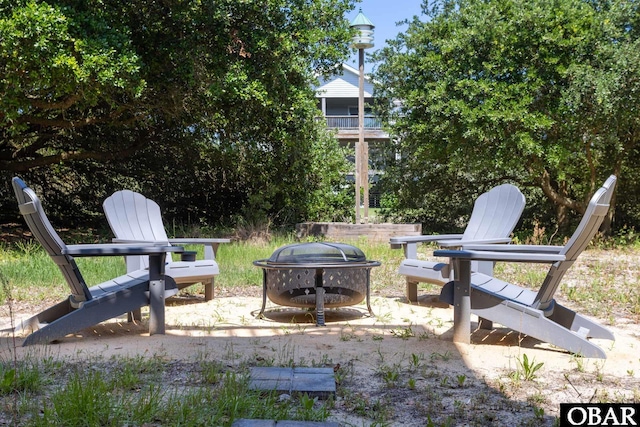 view of yard with an outdoor fire pit