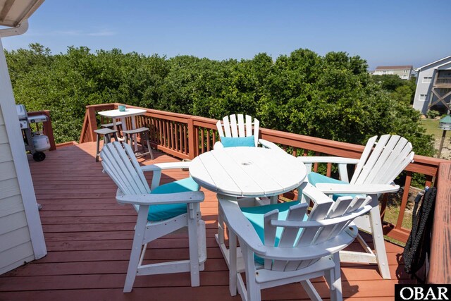 wooden terrace with outdoor dining area