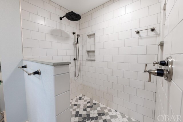 full bath featuring a tile shower