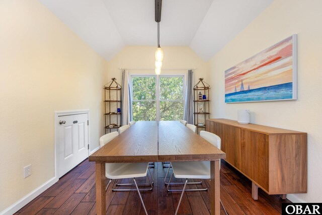 dining room with baseboards, vaulted ceiling, and dark wood-style flooring