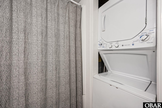 6317 S Virginia Dare Trl Unit 102, Nags Head, NC 27959 - laundry room featuring stacked washer / dryer