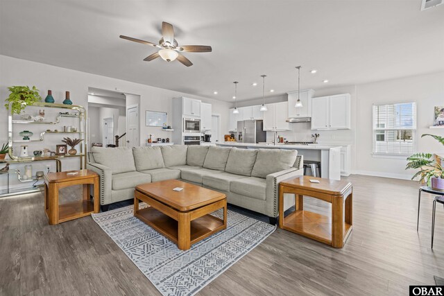 living area featuring recessed lighting, visible vents, ceiling fan, and wood finished floors