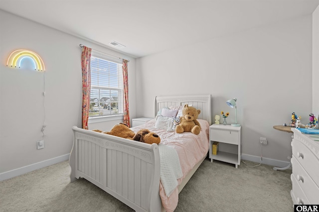 bedroom featuring light carpet and baseboards